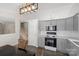 Open kitchen with gray cabinetry, white subway tile backsplash, and stylish pendant lighting at 3904 Crimson Wing Dr, Indian Trail, NC 28079