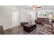 Open-concept living room with hardwood flooring, neutral walls, and comfortable brown leather furniture at 3904 Crimson Wing Dr, Indian Trail, NC 28079