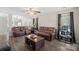 Cozy living room featuring hardwood floors, a ceiling fan, and comfortable, brown leather furniture at 3904 Crimson Wing Dr, Indian Trail, NC 28079