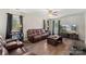 Comfortable living room featuring hardwood floors, natural light, and a leather sofa set at 3904 Crimson Wing Dr, Indian Trail, NC 28079