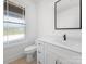 Charming bathroom features white cabinets, updated countertops and sink, modern fixtures, and large bright window at 3907 E Lawyers Rd, Monroe, NC 28110