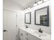 Bathroom boasts dual sinks, framed mirrors, and modern lighting fixtures at 3907 E Lawyers Rd, Monroe, NC 28110