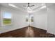 Bright bedroom with tray ceiling, hardwood floors, and large windows offering scenic views at 3907 E Lawyers Rd, Monroe, NC 28110