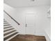 Entryway with hardwood floors, staircase with wood railing, white door, and built-in bench at 3907 E Lawyers Rd, Monroe, NC 28110