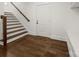 Bright entryway featuring wood stairs, a white door, hardwood floors, and a built-in bench at 3907 E Lawyers Rd, Monroe, NC 28110