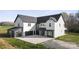 Stylish home featuring a contrasting black and white exterior, a spacious driveway, and a detached garage at 3907 E Lawyers Rd, Monroe, NC 28110