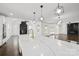 Modern kitchen with a large island, stylish pendant lighting, and an open view to the living room at 3907 E Lawyers Rd, Monroe, NC 28110