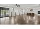 Spacious open-concept living room with hardwood floors, fireplace, staircase and kitchen view at 3907 E Lawyers Rd, Monroe, NC 28110