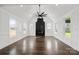 Spacious living room with high ceilings, hardwood floors, fireplace, large windows, and lots of natural light at 3907 E Lawyers Rd, Monroe, NC 28110