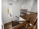Elegant staircase with wooden rails, black iron spindles, and a window, providing natural light at 3907 E Lawyers Rd, Monroe, NC 28110