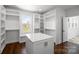 Spacious walk-in closet with custom built-in shelving and a center island for storage at 3907 E Lawyers Rd, Monroe, NC 28110