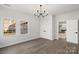 Inviting bedroom featuring hardwood floors, a modern chandelier, and ample closet space for comfortable living at 4012 Cambridge Hill Ln, Charlotte, NC 28270