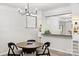 Charming dining area featuring modern chandelier, built-in shelving, and sleek bar area, perfect for entertaining guests at 4012 Cambridge Hill Ln, Charlotte, NC 28270