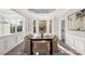 Bright dining room with hardwood floors, a modern chandelier, and multiple windows at 4012 Cambridge Hill Ln, Charlotte, NC 28270
