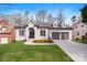 Charming brick home featuring a two-car garage and a well-manicured front yard at 4012 Cambridge Hill Ln, Charlotte, NC 28270