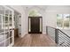 Bright foyer with hardwood floors, a modern railing, and a large arched doorway at 4012 Cambridge Hill Ln, Charlotte, NC 28270