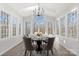 Bright sunroom features a modern chandelier, hardwood floors, and views of the outdoors at 4012 Cambridge Hill Ln, Charlotte, NC 28270