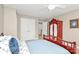 Bedroom with blue comforter, carpeted floor, and large armoire at 4205 New Town Rd, Waxhaw, NC 28173