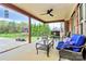 Relaxing covered patio with fan, outdoor furniture, and views of the backyard at 4205 New Town Rd, Waxhaw, NC 28173