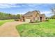 Beautiful brick home with attached garage, manicured lawn, and lush landscaping at 4205 New Town Rd, Waxhaw, NC 28173