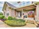 Inviting front porch with stone steps, decorative wreath, and lush landscaping at 4205 New Town Rd, Waxhaw, NC 28173