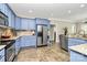 Well-appointed kitchen with stainless steel appliances, blue cabinets, and granite countertops at 4205 New Town Rd, Waxhaw, NC 28173