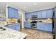Modern kitchen featuring blue cabinets, stainless steel appliances and beautiful countertops with tile backsplash at 4205 New Town Rd, Waxhaw, NC 28173