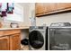 Well-equipped laundry room with modern washer, dryer, and ample storage space at 4205 New Town Rd, Waxhaw, NC 28173