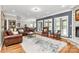 Elegant living room featuring hardwood floors, stone fireplace, and oversized windows offering abundant natural light at 4205 New Town Rd, Waxhaw, NC 28173