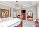 Relaxing main bedroom complete with decorative mirror, television, and comfortable seating at 4205 New Town Rd, Waxhaw, NC 28173