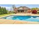 Stunning backyard pool reflects the home's brick exterior and covered patio at 4205 New Town Rd, Waxhaw, NC 28173