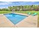Backyard pool with slide and lounge chairs surrounded by a black metal fence at 4205 New Town Rd, Waxhaw, NC 28173
