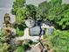 Charming home with a curved driveway, lush trees, and a detached garage, creating a private and inviting setting at 4601 Crooked Oak Ln, Charlotte, NC 28226