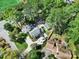 Desirable home featuring a lush landscape, detached garage, mature trees, and well-manicured lawn at 4601 Crooked Oak Ln, Charlotte, NC 28226