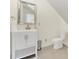 Bathroom features white vanity, neutral walls, tile floors, silver framed mirror and modern fixtures at 4601 Crooked Oak Ln, Charlotte, NC 28226