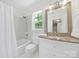 Bright bathroom with a shower-tub, granite counter, and neutral color palette creates a clean, modern aesthetic at 4601 Crooked Oak Ln, Charlotte, NC 28226