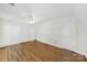 Bedroom features hardwood floors, white walls, white trim, a ceiling fan, and two closets with white doors at 4601 Crooked Oak Ln, Charlotte, NC 28226