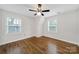 Attic bedroom features hardwood floors, white walls, white trim, and two windows for natural light at 4601 Crooked Oak Ln, Charlotte, NC 28226