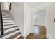 Inviting entryway featuring hardwood floors and staircase, creating a warm and welcoming ambiance at 4601 Crooked Oak Ln, Charlotte, NC 28226