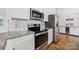 Modern kitchen with stainless steel appliances, granite countertops, and ample cabinet space at 4601 Crooked Oak Ln, Charlotte, NC 28226