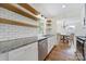 Bright kitchen featuring granite countertops, stainless steel appliances and open shelving at 4601 Crooked Oak Ln, Charlotte, NC 28226