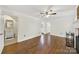 Living room with hardwood flooring leading into the hall and a view into a bathroom at 4601 Crooked Oak Ln, Charlotte, NC 28226