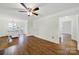 Living room with hardwood flooring flowing into an open floor plan including the kitchen and dining at 4601 Crooked Oak Ln, Charlotte, NC 28226