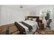 Beautifully staged main bedroom featuring a ceiling fan, hardwood floors, and a large window for natural light at 4601 Crooked Oak Ln, Charlotte, NC 28226