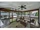 Inviting screened porch with wooden furniture and decor, perfect for relaxation and enjoying the outdoors at 4601 Crooked Oak Ln, Charlotte, NC 28226