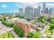 Condo building with city skyline views and mature landscaping at 715 N Church St # 301, Charlotte, NC 28202