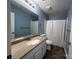 Bathroom featuring a large mirror, white vanity, and shower-tub combo at 715 N Church St # 301, Charlotte, NC 28202