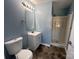 Full bathroom featuring blue walls, a white vanity, and walk-in shower at 715 N Church St # 301, Charlotte, NC 28202