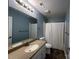 Bathroom featuring a large mirror, white vanity, and shower-tub combo at 715 N Church St # 301, Charlotte, NC 28202