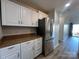 Well-lit kitchen featuring white cabinets, countertops, and stainless steel refrigerator at 715 N Church St # 301, Charlotte, NC 28202
